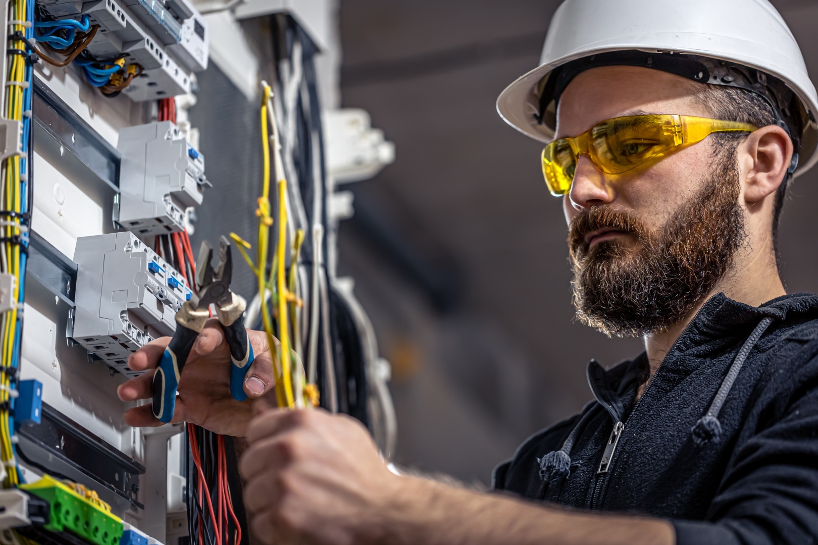 male-electrician-works-switchboard-with-electrical-connecting-cable.jpg